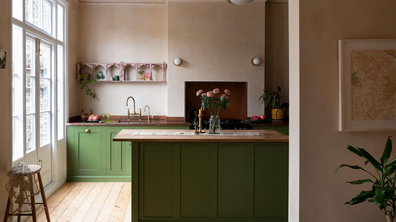 Classic English cupboards within a Victorian terrace. Light green painted shakers with oak countertops 