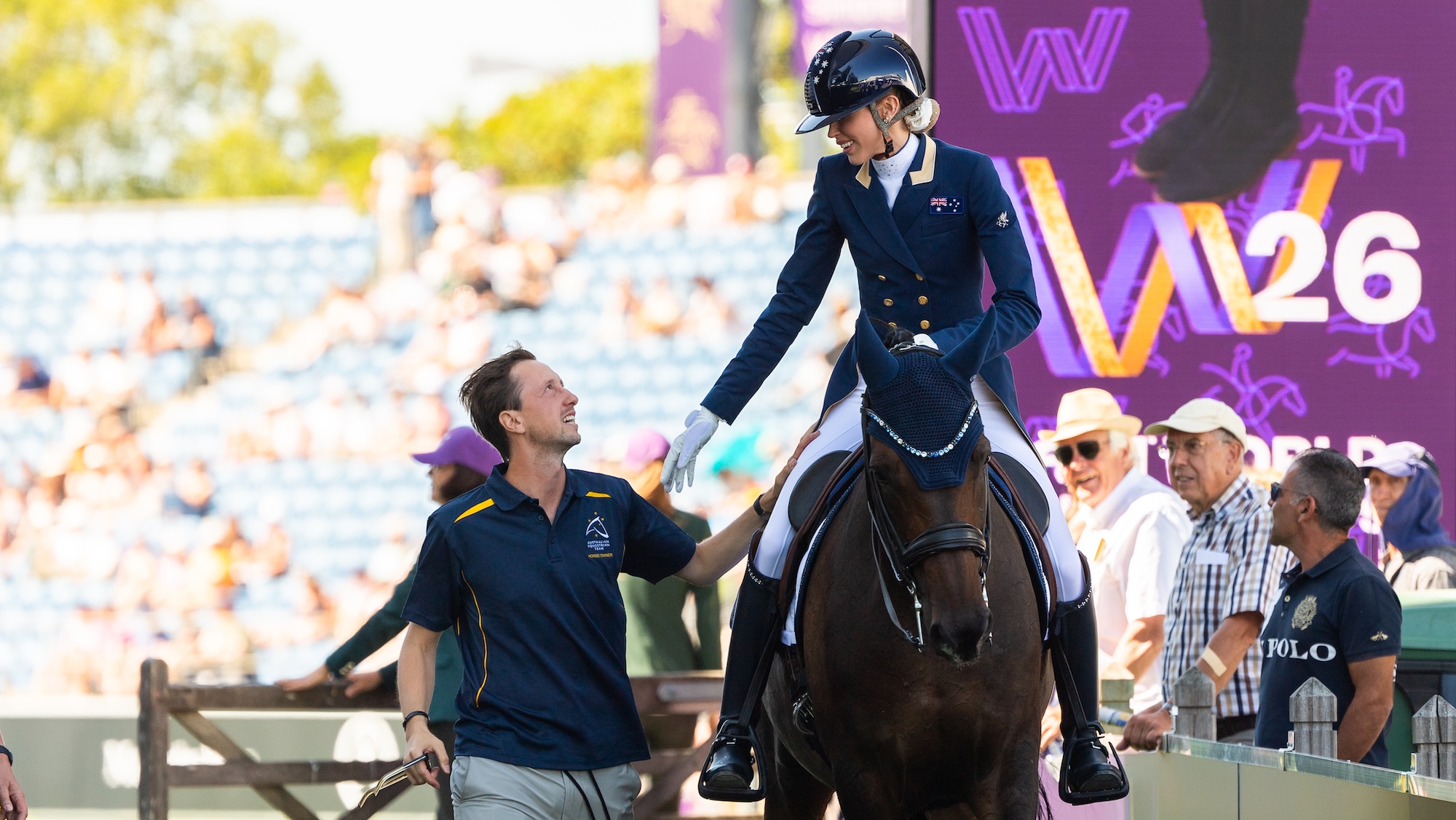 Image shows a horse and rider, with their supporter walking alongside them