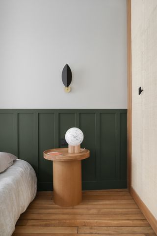 A bedroom with painted paneling
