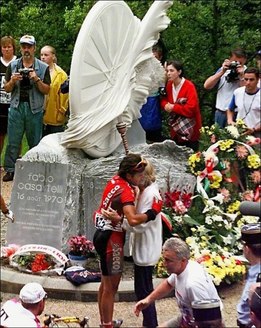 Italian cyclist Gian Matteo Fagnini embraces Fabio Casartelli's mother during a ceremony near the monument built in memory of her son in the Portet d'Aspet.