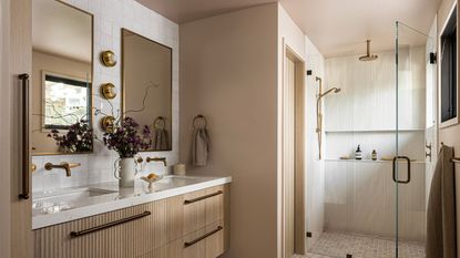 A wood bathroom with white wall tiles and two rectangular mirrors above the double vanity