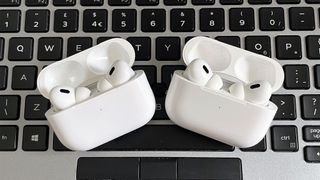Apple AirPods Pro 2 USB-C next to AirPods Pro 2 (2022) on a keyboard