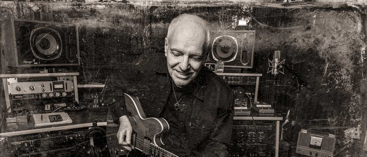 Peter Frampton with guitar (studio portrait)