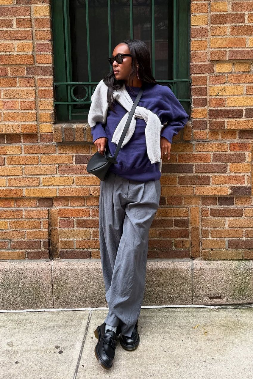 a woman wearing black loafers
