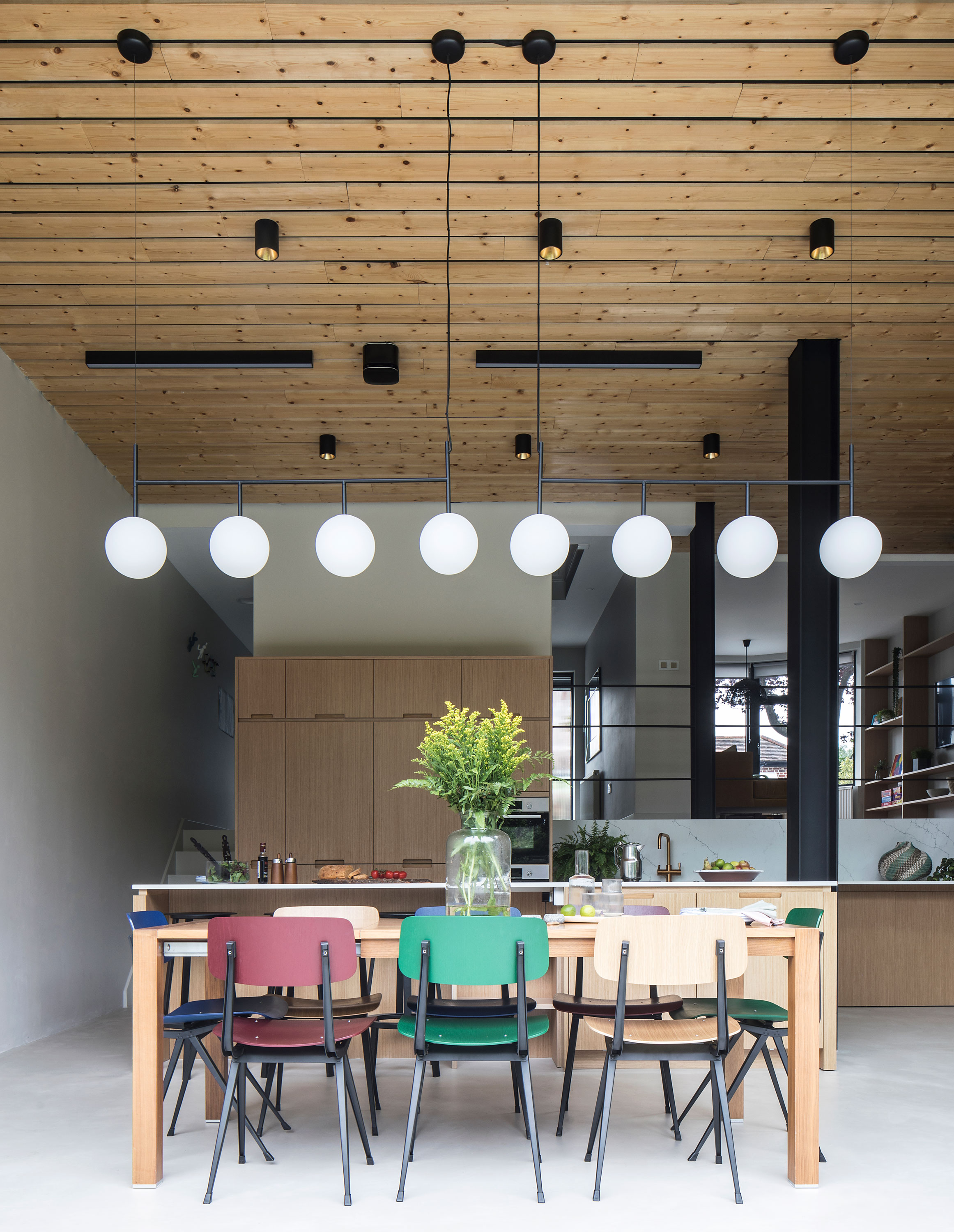 Modern kitchen design with wooden ceilings and statement lighting