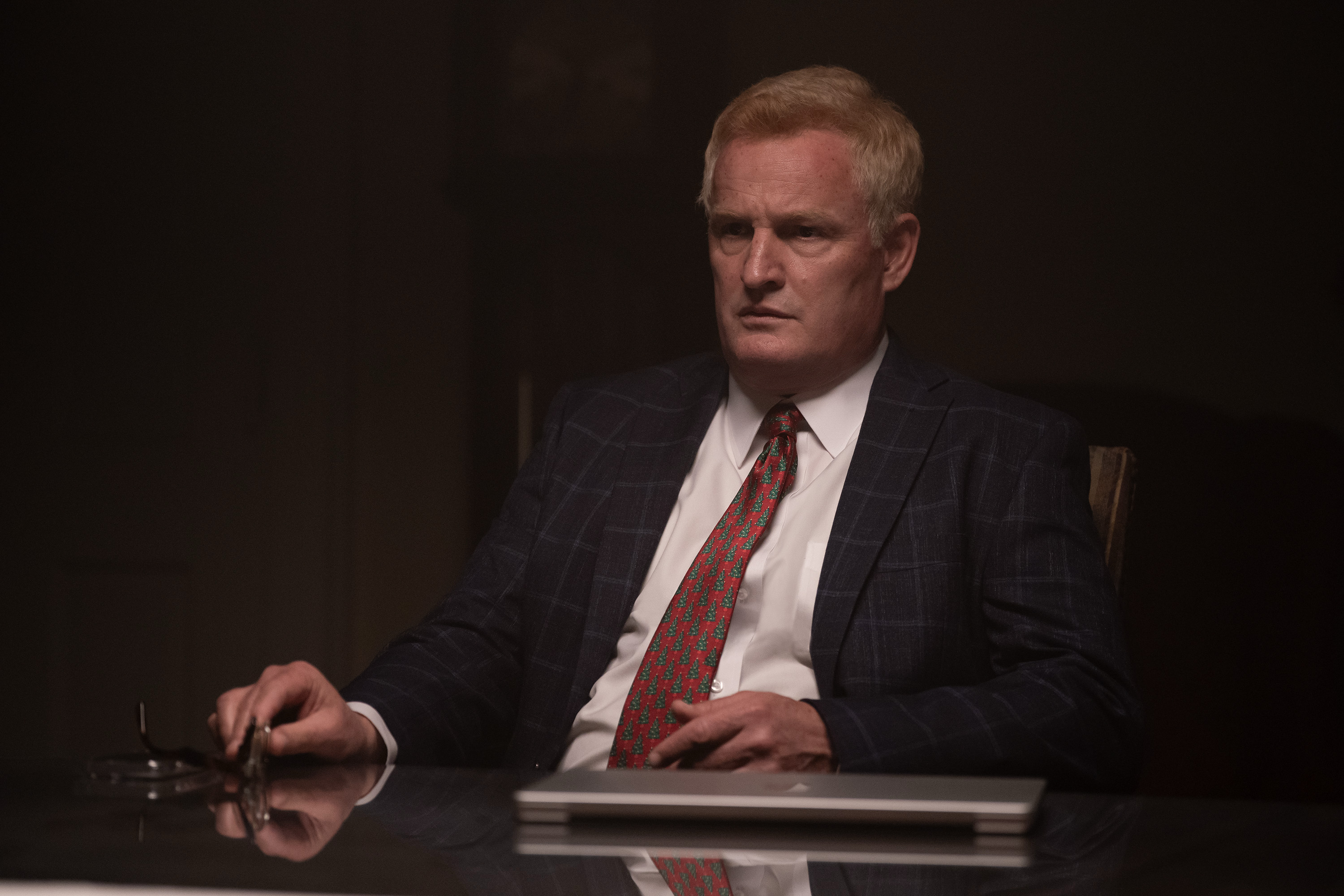 Jason Clark as Alex Murdaugh wearing a suit and sitting at his desk in murdaugh a death in the family