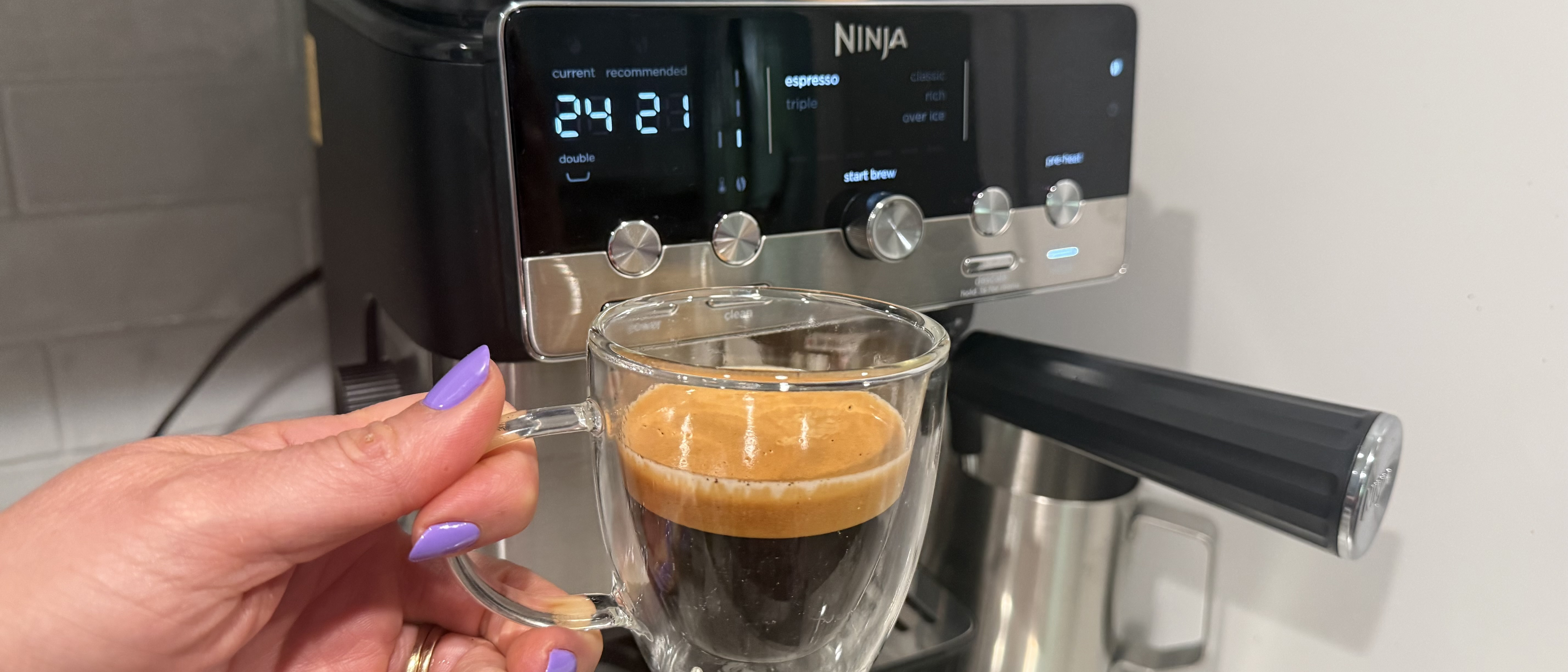 Ninja Luxe Caf&eacute; Mini coffee maker with cup of freshly brewed espresso