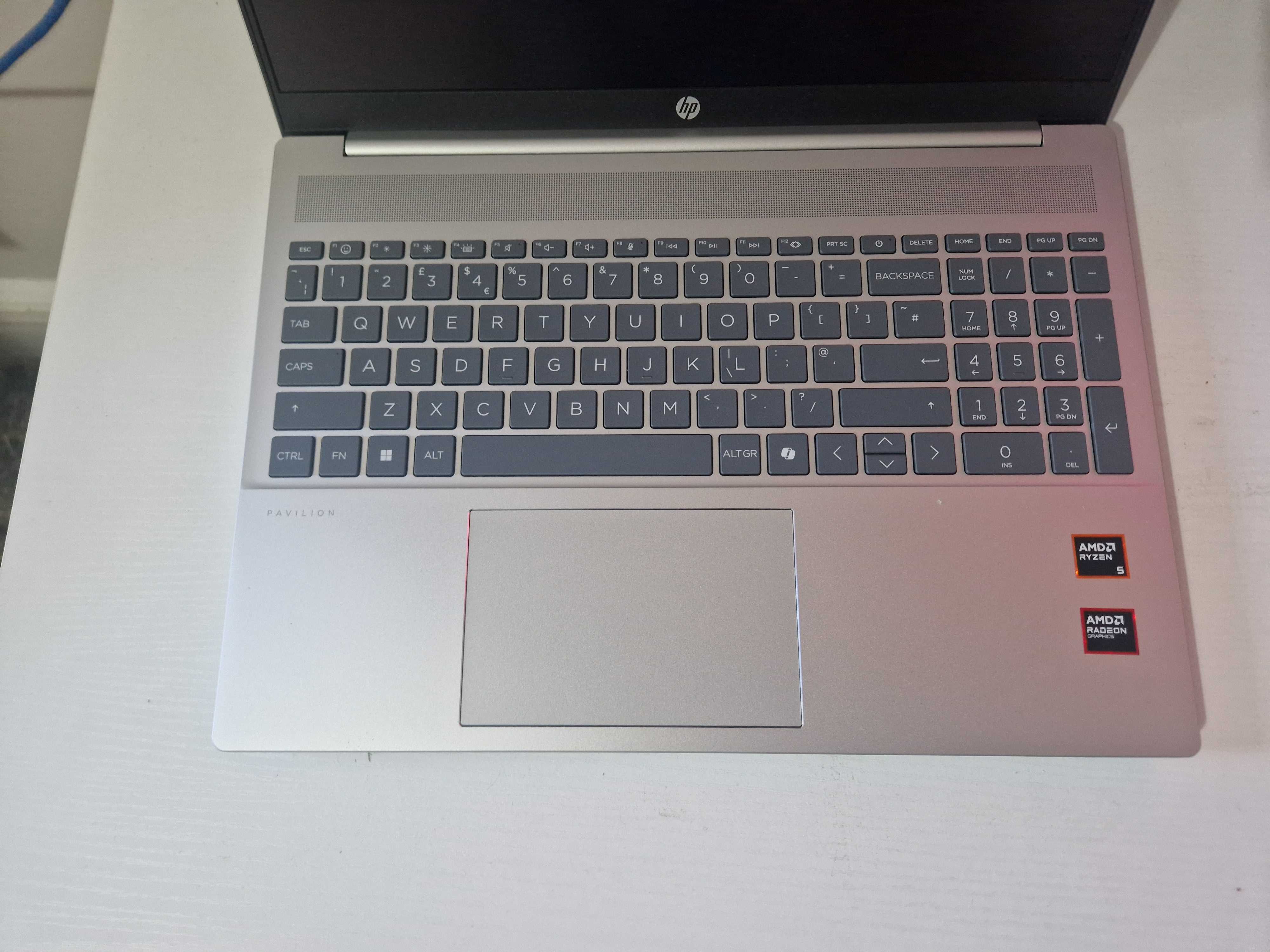 A silver HP Pavilion 16 sitting on a white desk