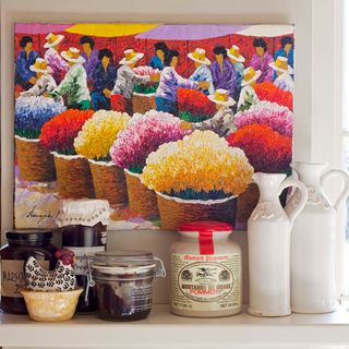 Painting on wall with vase and tins
