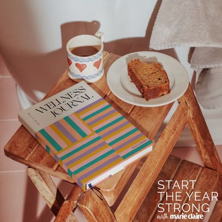 papier wellness journal with cup of tea and slice of cake