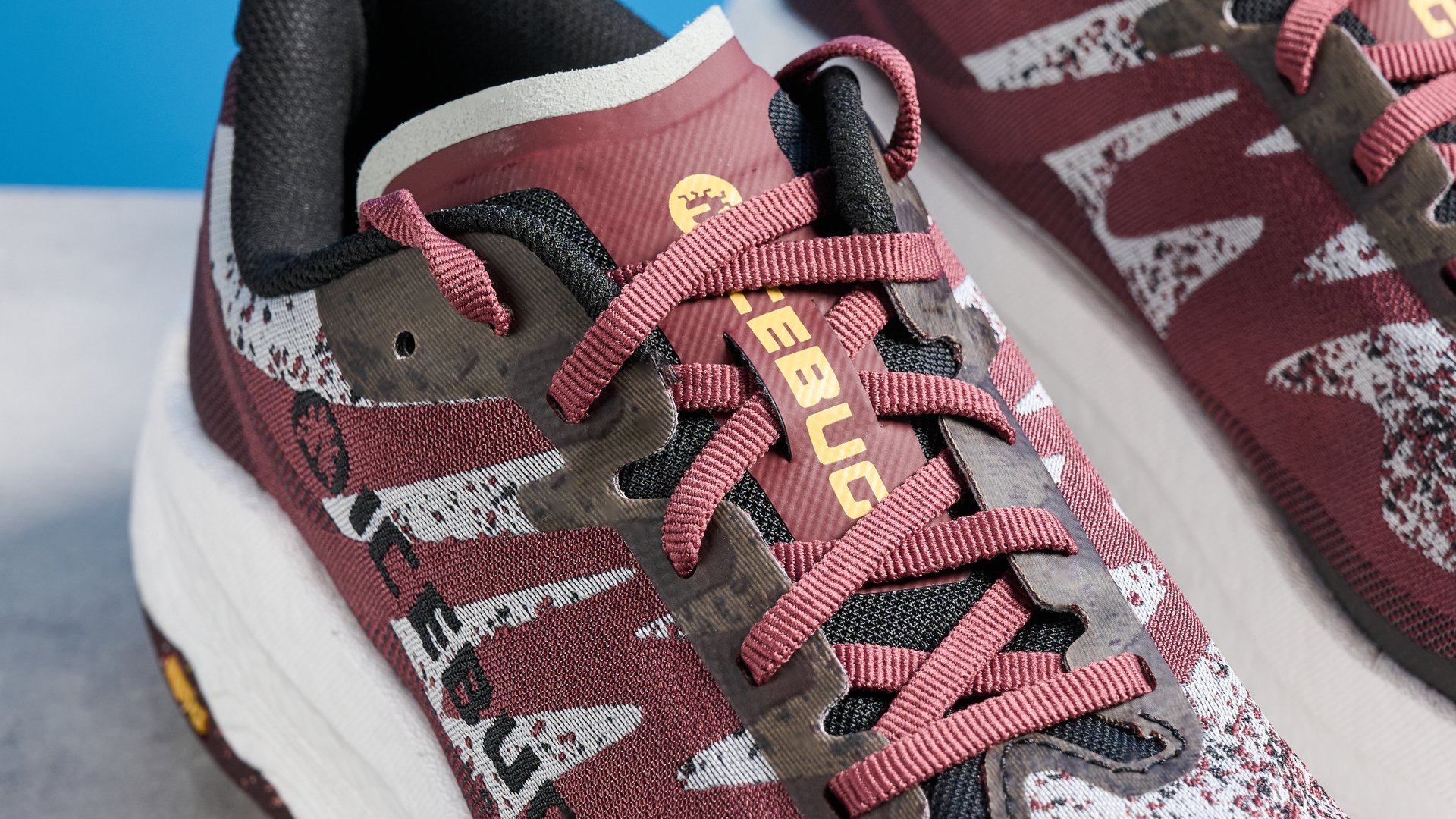 the icebug j&amp;auml;rv rb9x trail running shoes in cherry and banana photographed against the tom's guide blue background