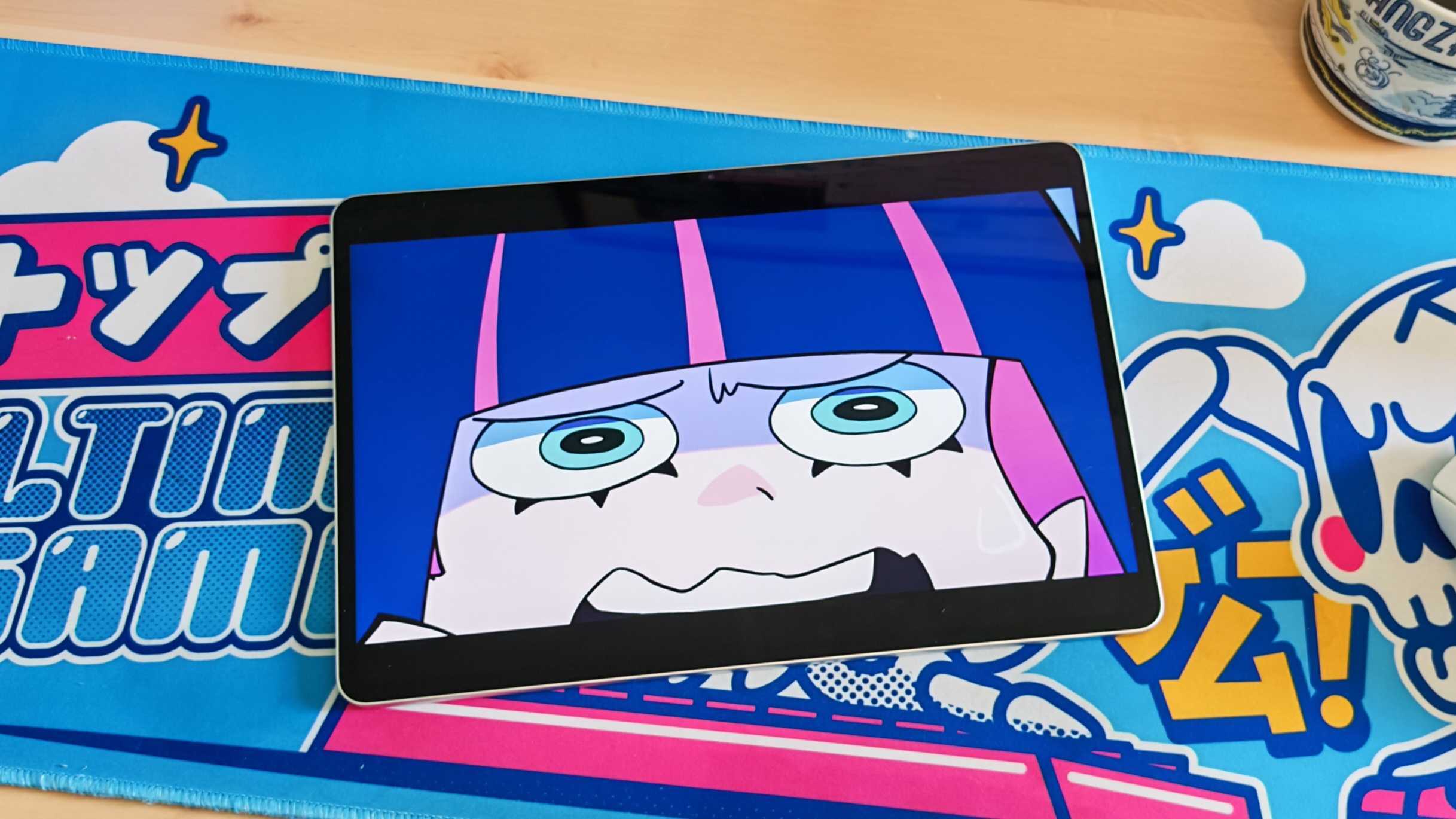 The Honor MagicPad 3 placed on a colorful desk mat.