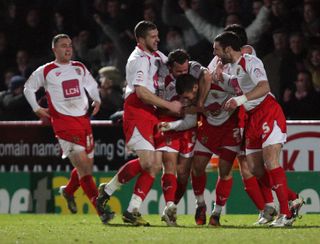 Stevenage players celebrate after Michael Bostwick scored their second goal against Newcastle in the FA Cup, 2011