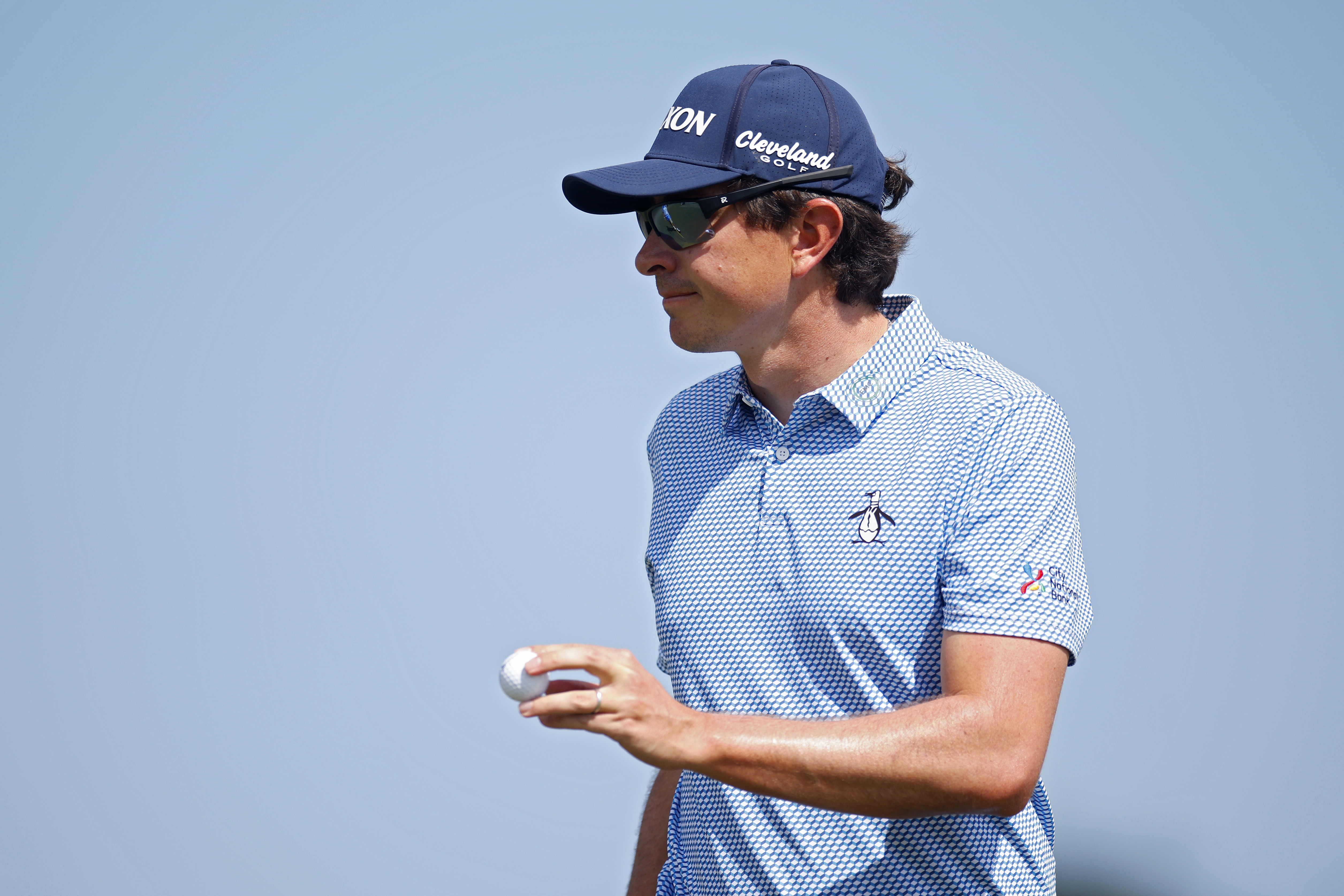 Nico Echavarria waves to the crowd holding a golf ball