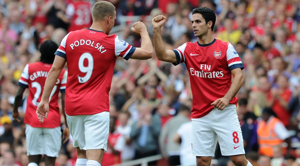 Arsenal&#039;s Lukas Podolski and Mikel Aretat bump fists during the Premier League match between Arsenal and Southampton on 15 September, 2012 at the Emirates Stadium in London, United Kingdom.