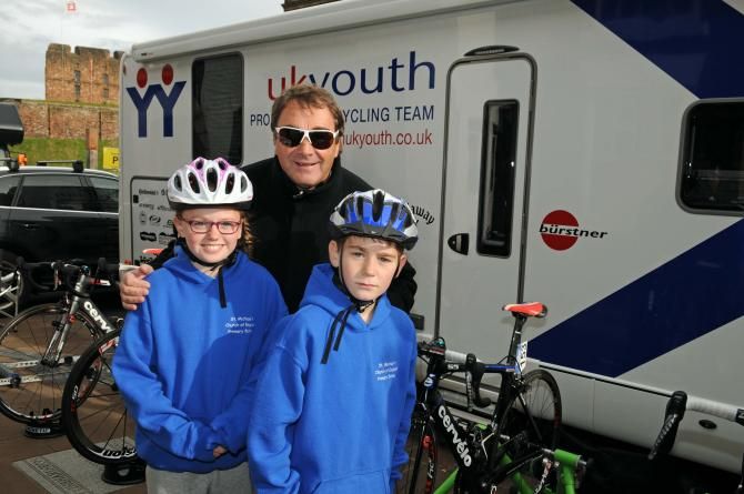 Motor racing legend Nigel Mansell with fans by the UK youth bus