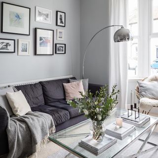 grey living room with carpet flooring and photo frames