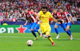 Mohamed Salah of Liverpool scores their side's third goal from the penalty spot during the UEFA Champions League group B match between Atletico Madrid and Liverpool FC at Wanda Metropolitano on October 19, 2021 in Madrid, Spain.