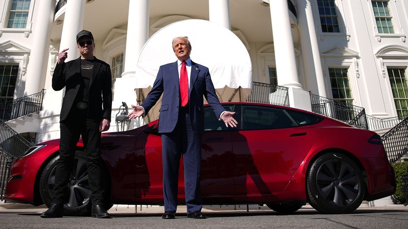 Trump stood in front of a red Tesla next to Elon Musk