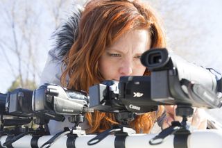 Best camcorders: A woman with red hair tests out a line of camcorders