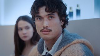 Austin (Charles Melton) looks ahead, as Ashley (Cailee Spaeney) looks to the side on Beef.
