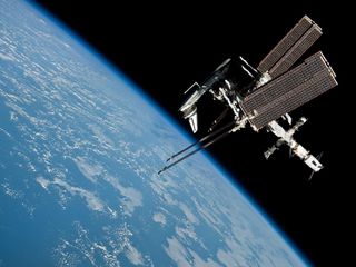The International Space Station floats approximately 220 miles above the Earth with space shuttle Endeavour docked to it. Expedition 27 crew member Paolo Nespoli took the photograph from the Soyuz TMA-20 spacecraft as he and two other astronauts departed