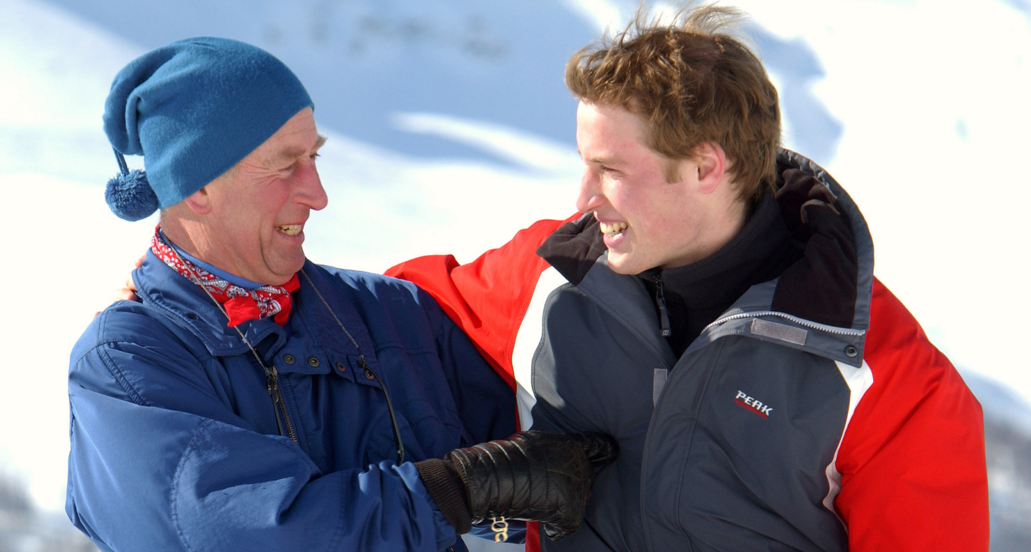 Prince William and King Charles laughing wearing ski gear