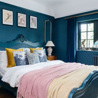 dark blue bedroom with painted bed