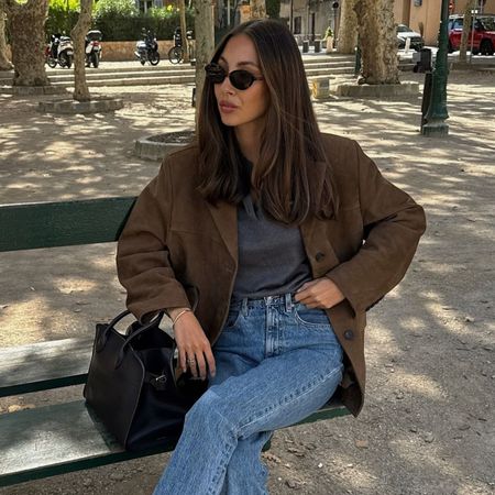 Woman wears brown suede blazer, blue jeans