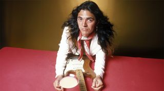 Tommy Bolin, posed with guitar and cocktail, June 1975
