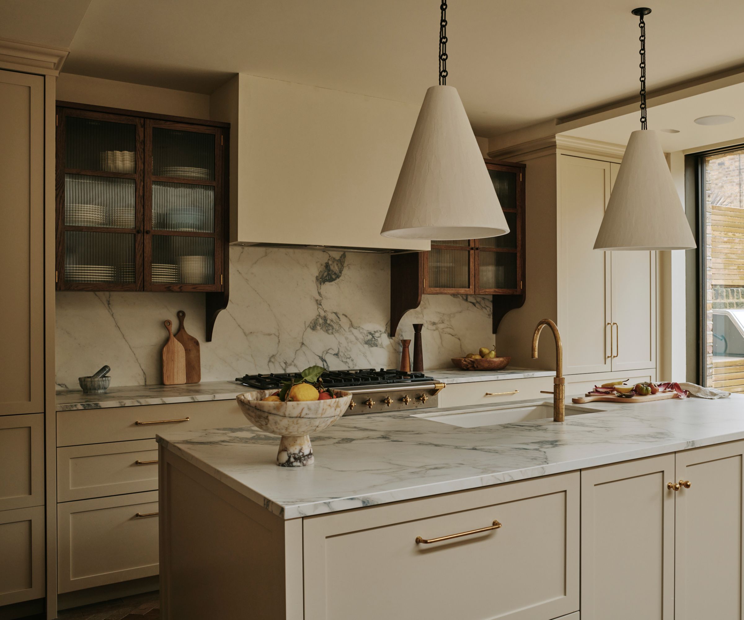 A neutral kitchen with marble countertops