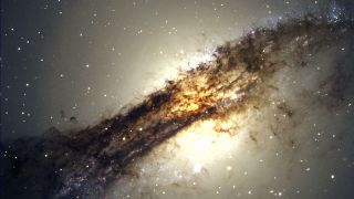 a radio galaxy with dark wispy structures expanding out from the center with a bright yellow light at the heart.