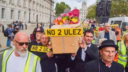 Protesters carry a coffin through London with a number plate reading "No 2 Ulez"