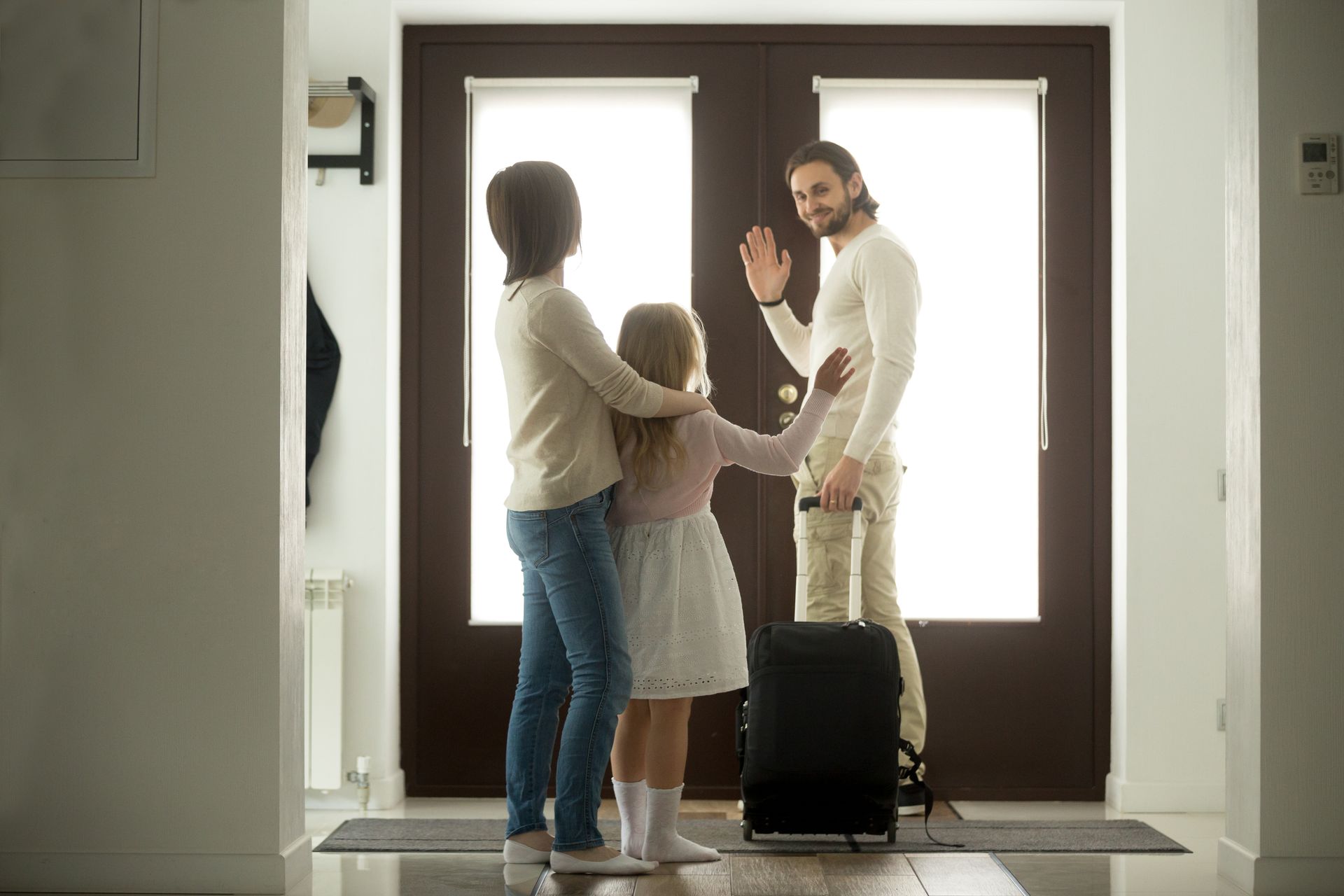 father <b>leaving</b> <b>home</b> waving to wife and daughter.