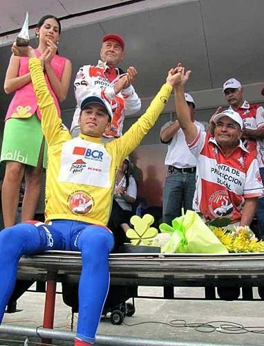 Race leader Gregory Brenes (BCR-Pizza Hut-KHS-Powerade) salutes from the podium.