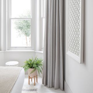 Grey curtains in white bedroom