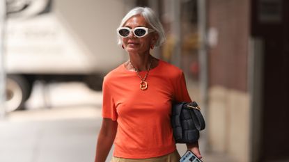 best serums for mature skin - Grece Ghanem is seen outside Tibi show wearing white Bottega Veneta sunnies, red earrings, old Celine necklace, orange tshirt 