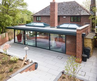 modern orangery kitchen extension in brick and dark grey aluminium viewed from outside