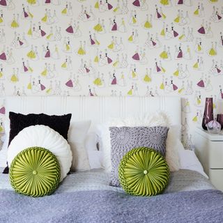 bedroom with wallpaper and headboard