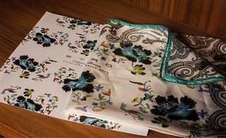 floral-printed card and matching scarf, bordered in the brand's signature paisley