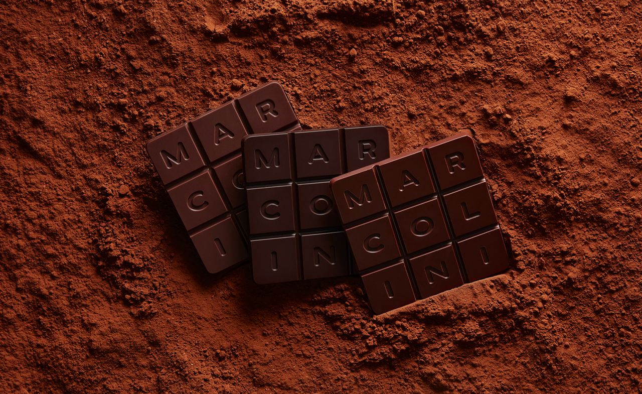 Pierre Marcolini Grand Cru square chocolate tablets with &#039;MARCOLINI&#039; lettering surrounded by chocolate powder