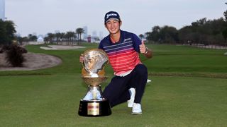Japanese golfer Rikuya Hoshino poses with the 2024 Qatar Masters trophy