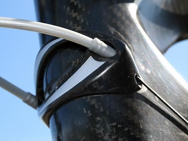 A carbon fibre head tube badge retains the clever integrated housing stops.