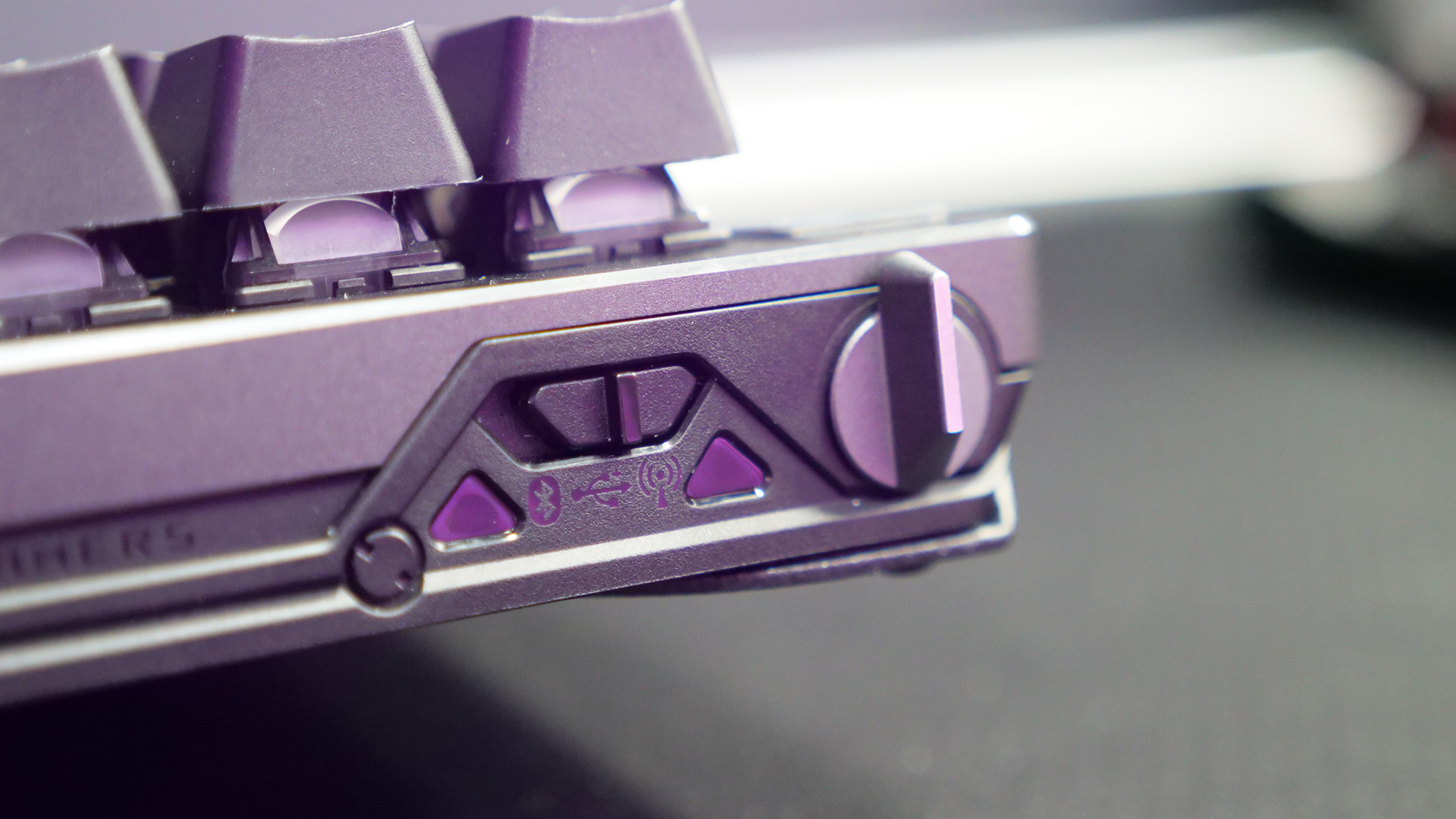 Back corner of the Asus ROG Falcata gaming keyboard showing the connectivity switch and Rapid Trigger toggle.