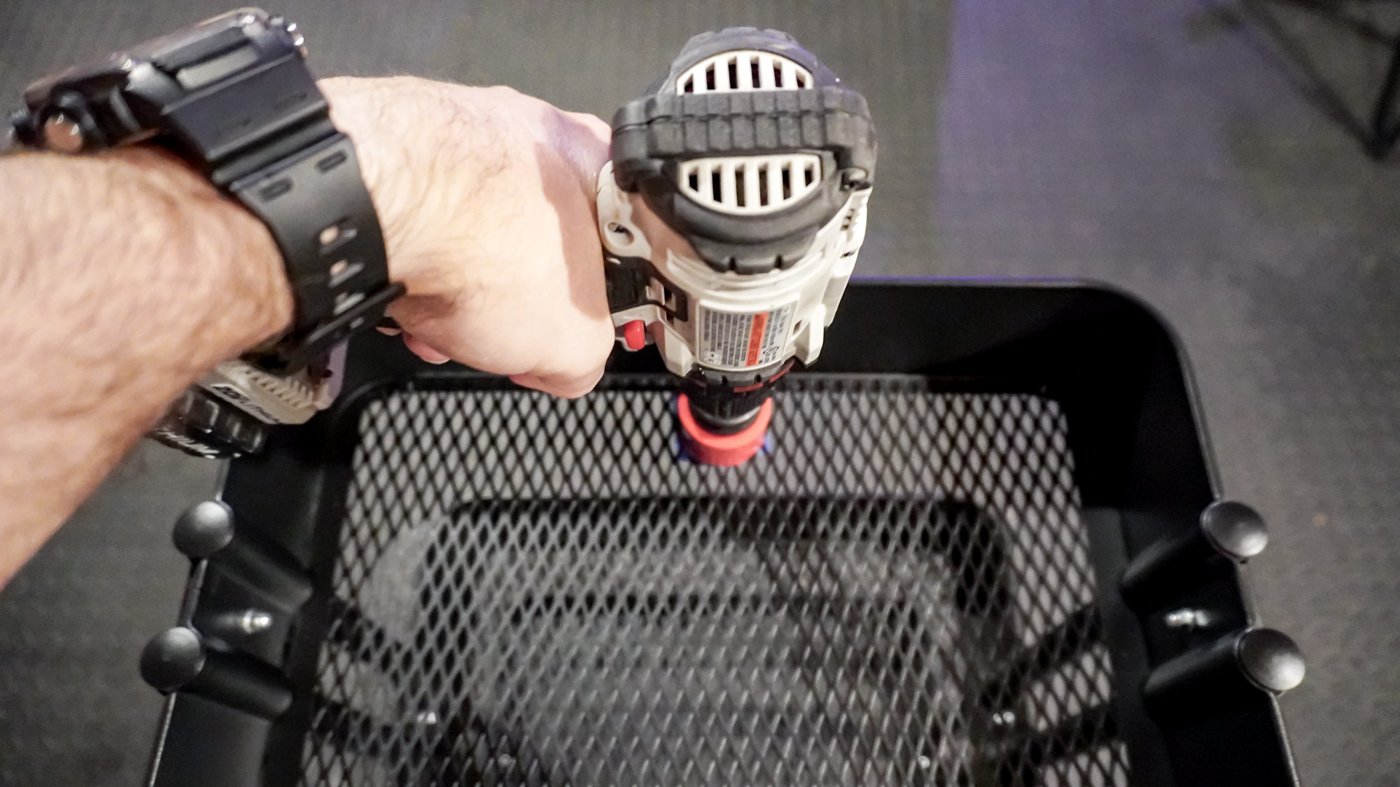 Using a power drill to drill a circular hole in the Ikea Raskog utility cart