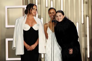 Karla Sofía Gascón, Zoe Saldana, and Selena Gomez speak onstage during the TIFF Tribute Awards during the 2024 Toronto International Film Festival at Fairmont Royal York on September 08, 2024 in Toronto, Ontario.