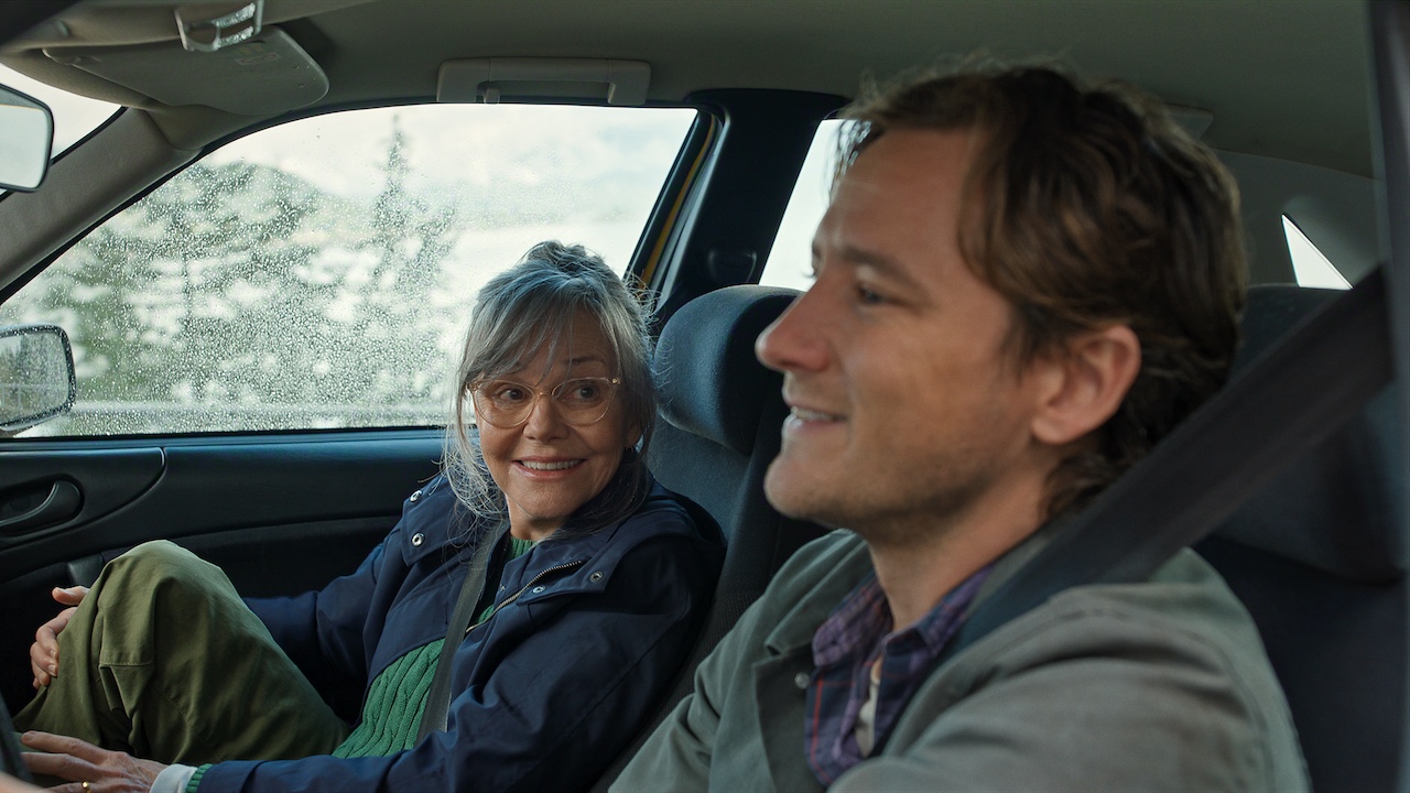 Sally Field as Tova and Lewis Pullman as Cameron in a car together in Remarkably Bright Creatures