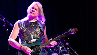 Steve Morse plays his blue signature Ernie Ball Music Man onstage with the Dixie Dregs, 2024