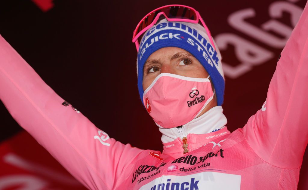 Team Deceuninck rider Portugals Joao Almeida celebrates on the podium as he receives the overall pink jersey after the 12th stage of the Giro dItalia 2020 cycling race a 204kilometers route between Cesenatico and Cesenatico on October 15 2020 Photo by Luca Bettini AFP Photo by LUCA BETTINIAFP via Getty Images