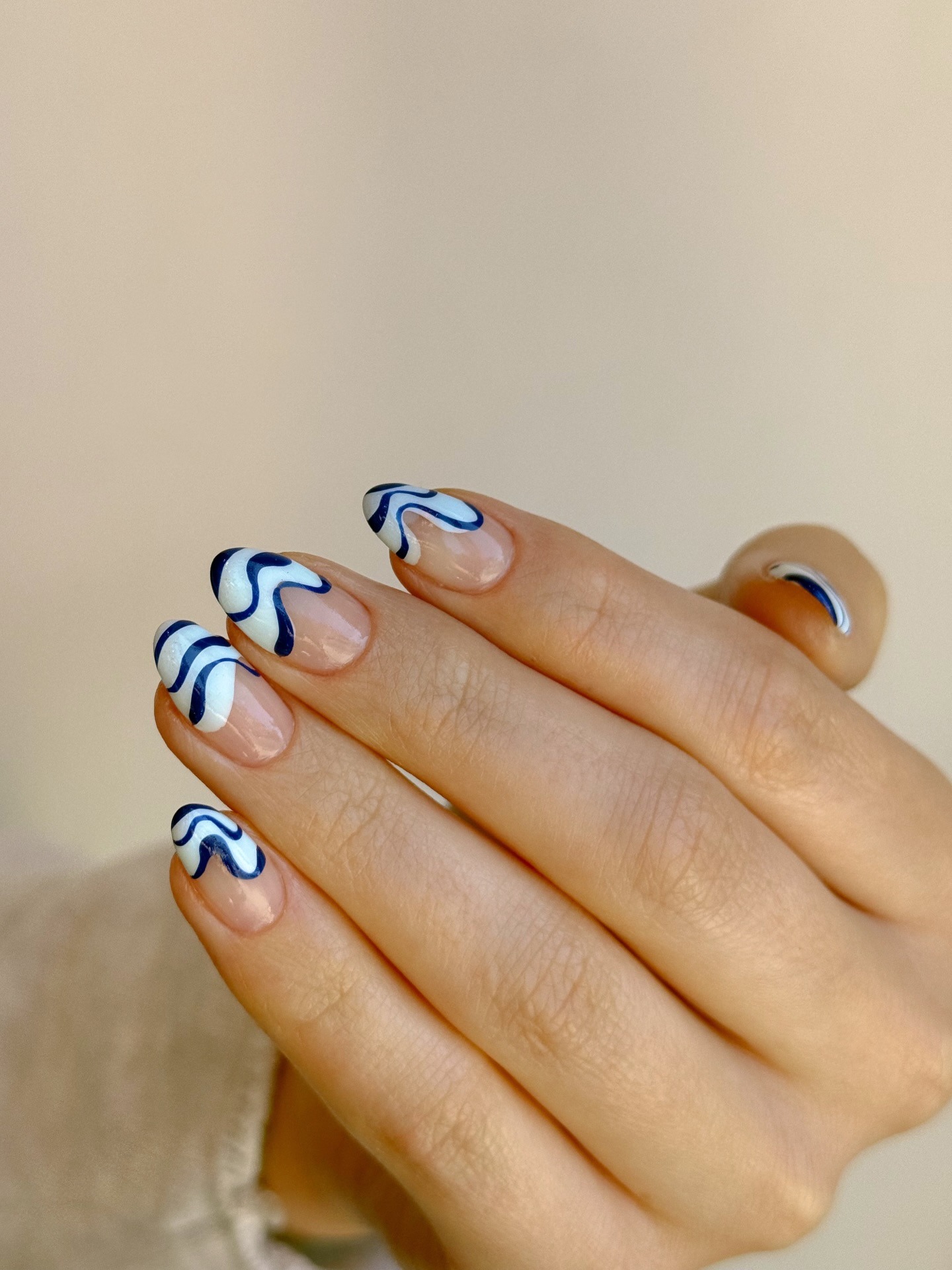 A blue French tip swirl nail design